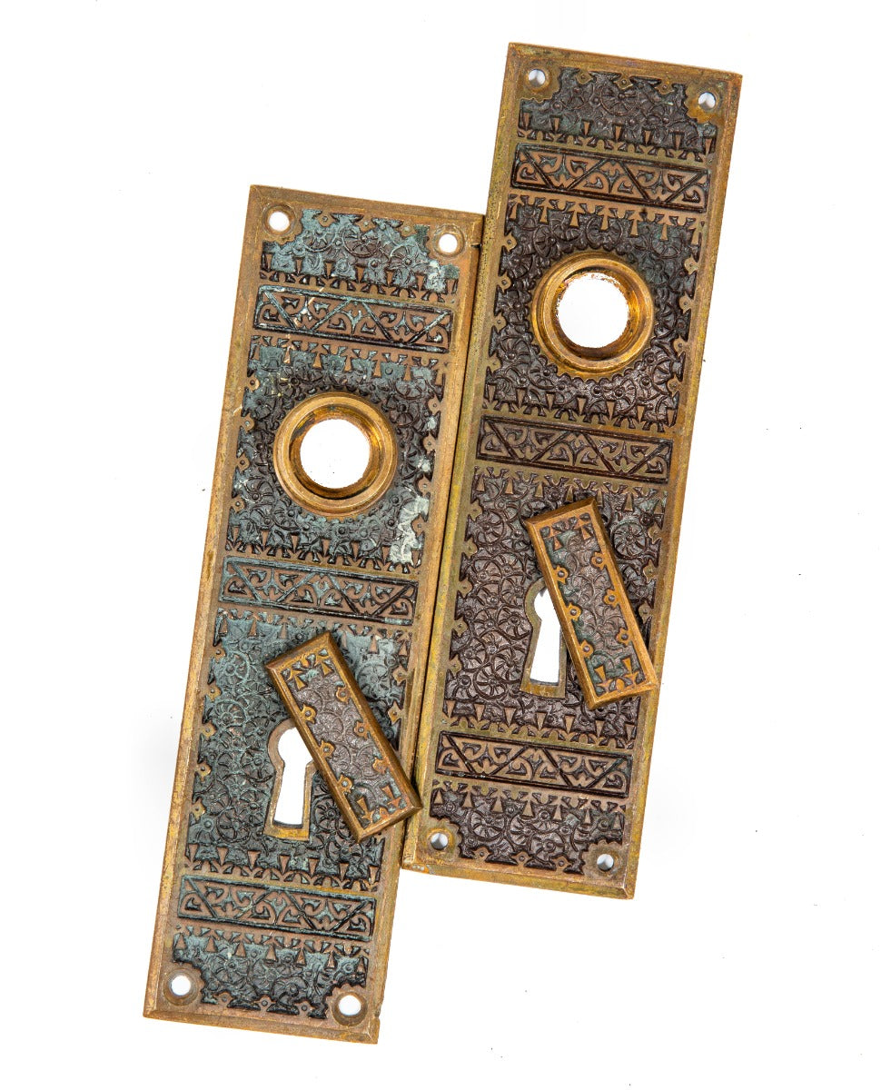 matching set of hard to find 1880s eastlake style "brocade" pattern residential doorknob backplates with swinging keyhole covers
