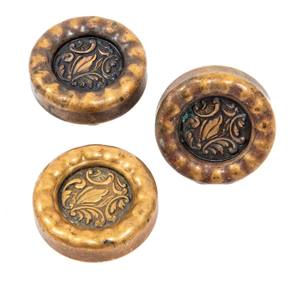 group of matching early 20th century wrought ornamental bronze "eulalia" pattern doorknobs with sunken centers