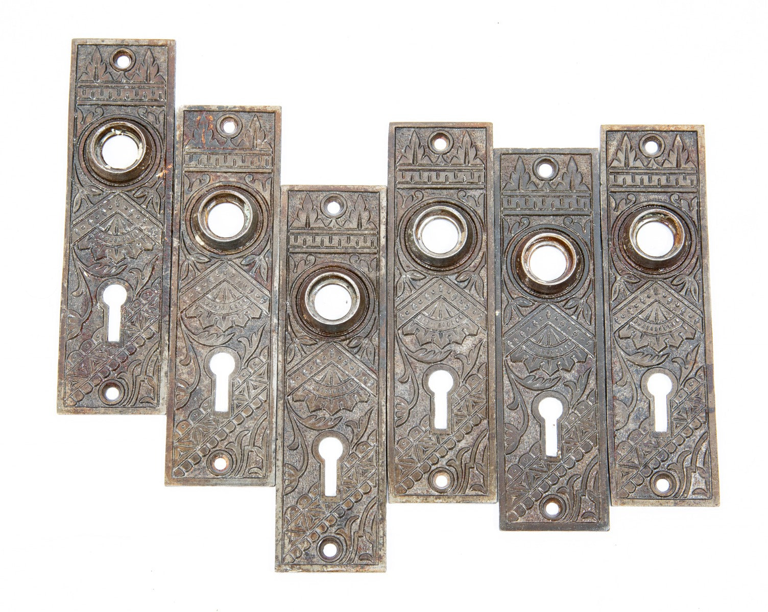 several matching 1880s ornamental cast iron "oriental" pattern interior residential doorknob backplates