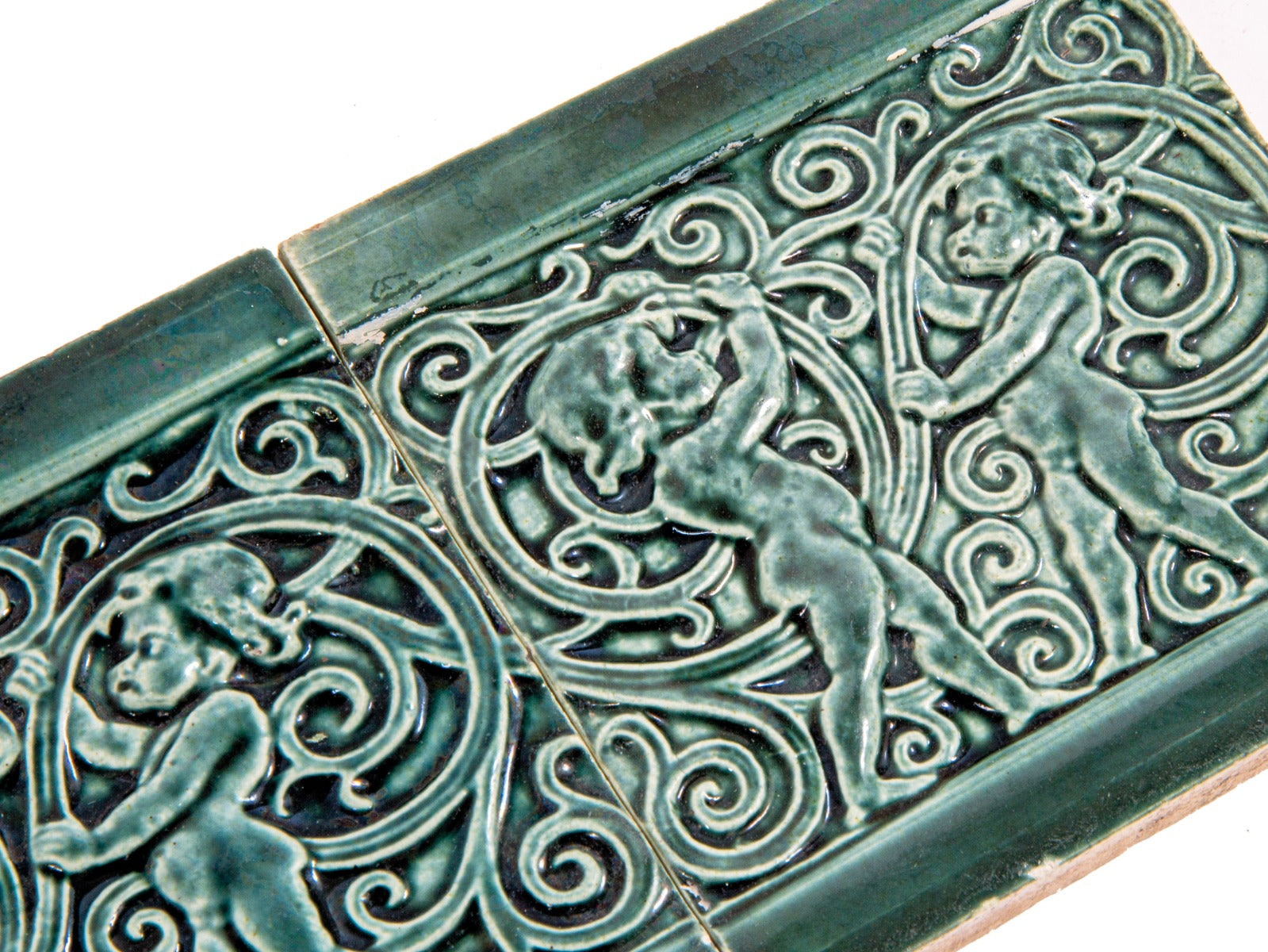 TWO matching original hard to find seagreen colored 1880s j. and j.g. low art tiles with foilage and cherubs