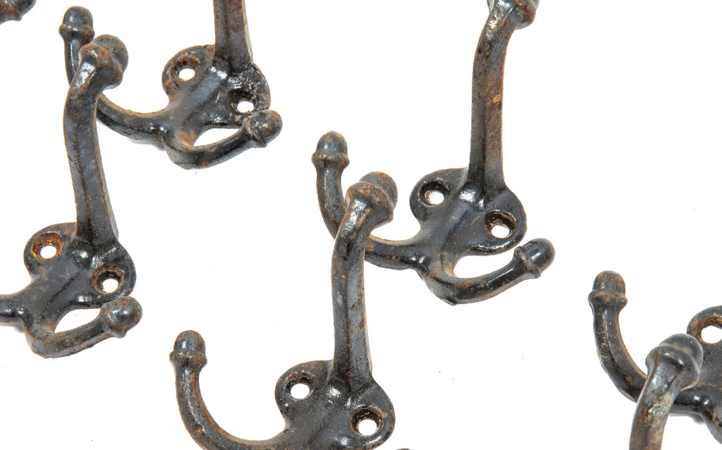 large lot of original early 20th century cast iron salvaged chicago schoolhouse hooks with acorn finials