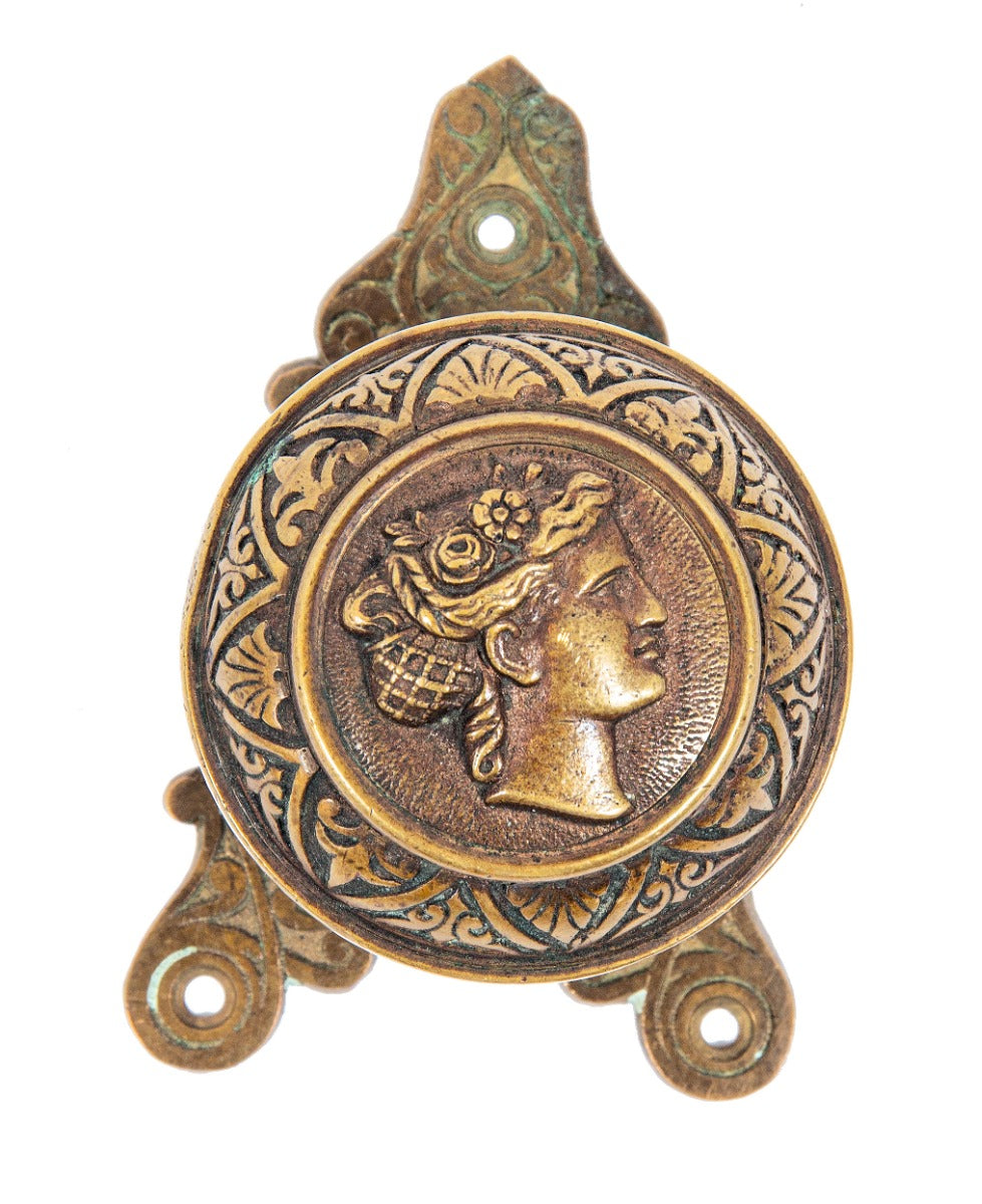 1870s cast bronze "goddess diana" residential banded rim figural doorknob with matching triangular-shaped backplate