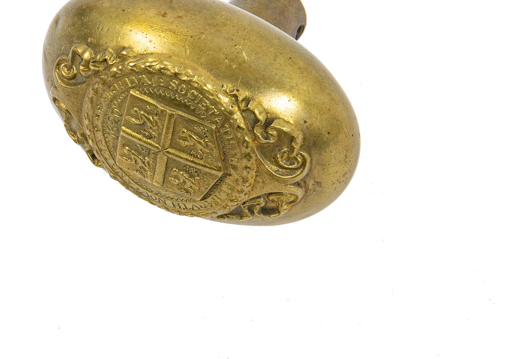original early 20th century ornamental cast brass plymouth county oval-shaped emblematic doorknob