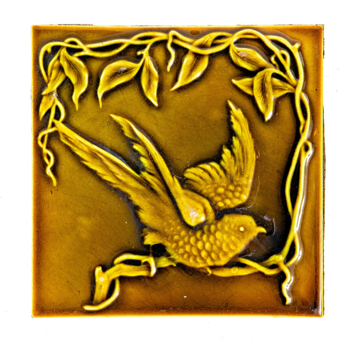 single original 19th century light olive-colored 6 x 6 inch majolica figural tile with winged bird and plant motifs