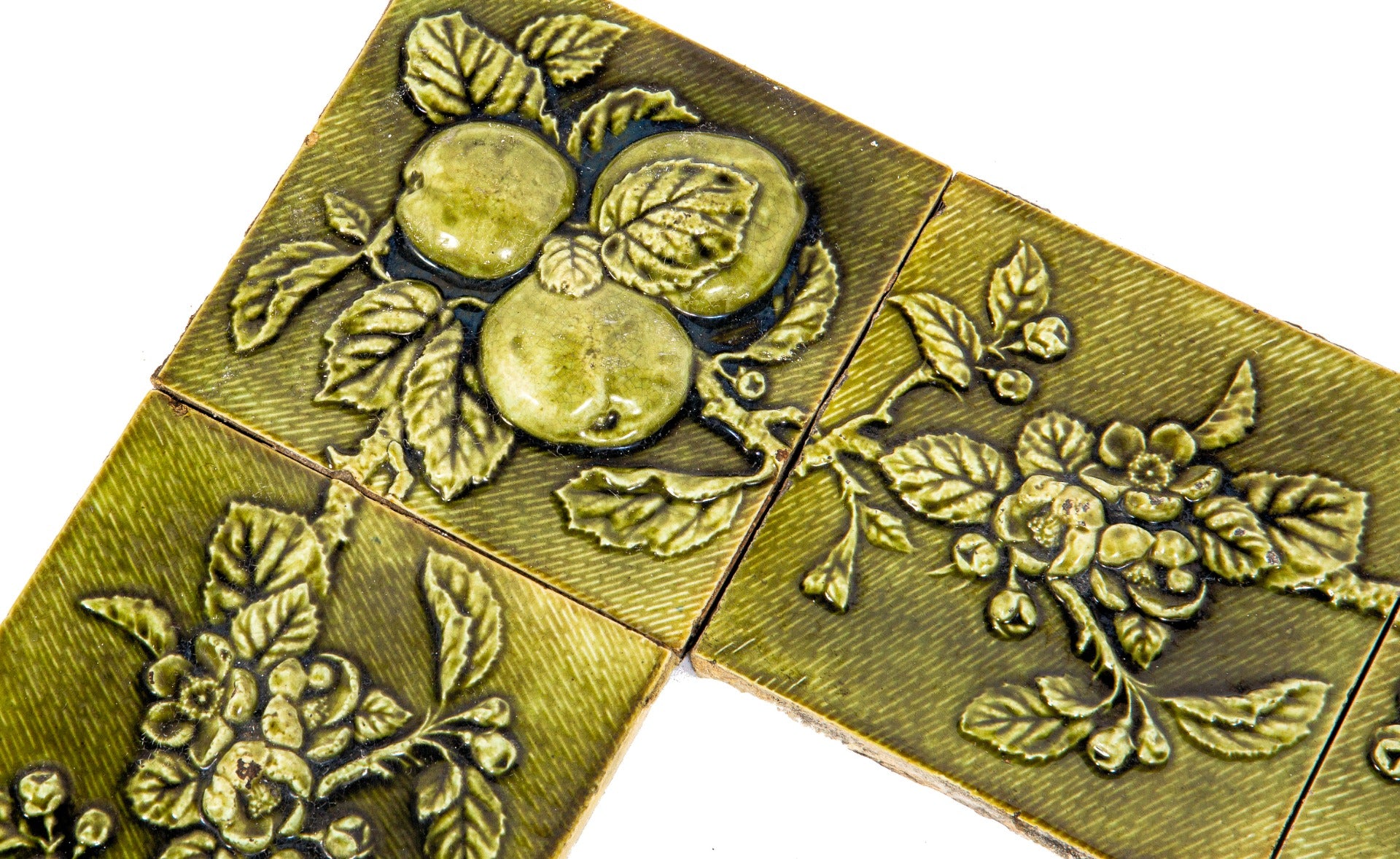 all original and amazingly intact late 1880's deeply embossed fruit and vine green majolica glazed fireplace mantel tile surround