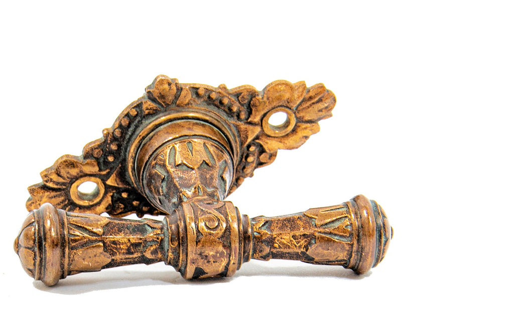 very rare and metallic compression casting company diminutive rotating ornamental 19th century bronze t-handle with matching escutcheon