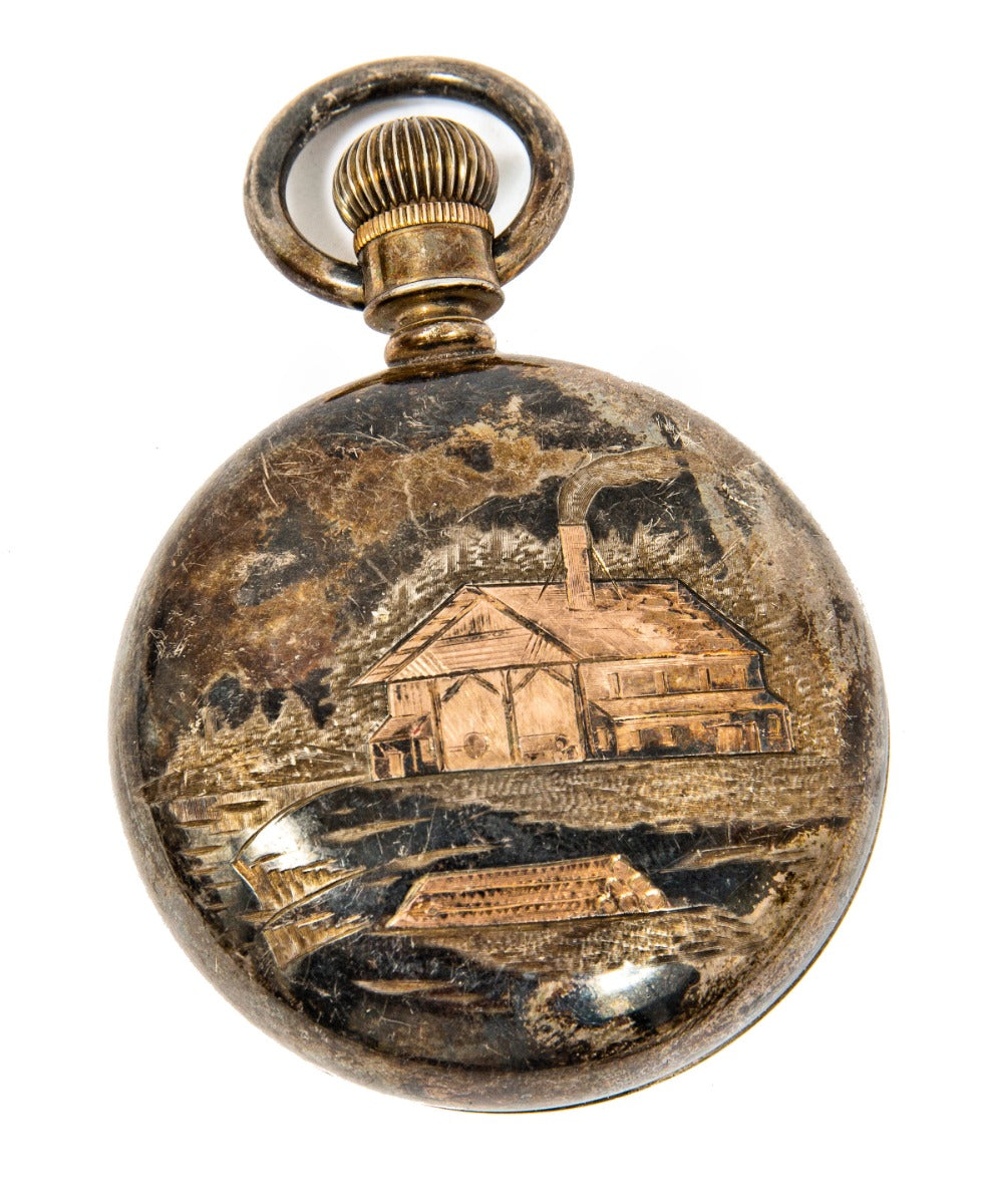 late 19th or early 20th century folk art pocket watch case with lighly incised cabin and river scene