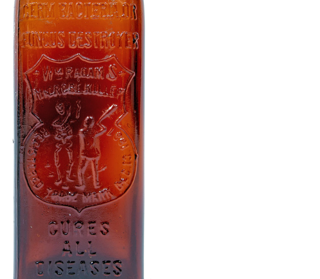 rare late 19th century antique american medical dark amber or brown glass "radam's microbe killer" embossed medicinal bottle with tooled plain lip