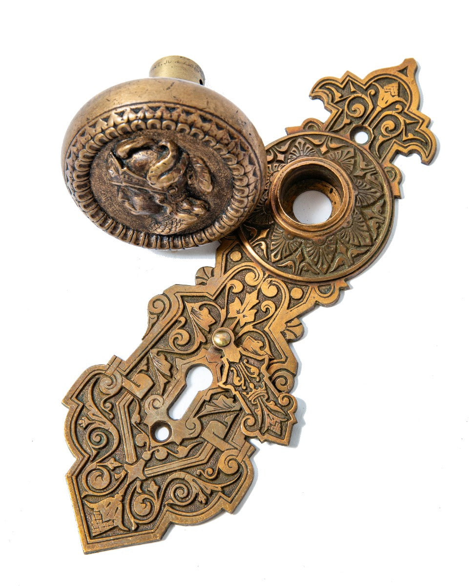 original 1870s metal compression casting company plumed knight doorknob and matching entrance door backplate