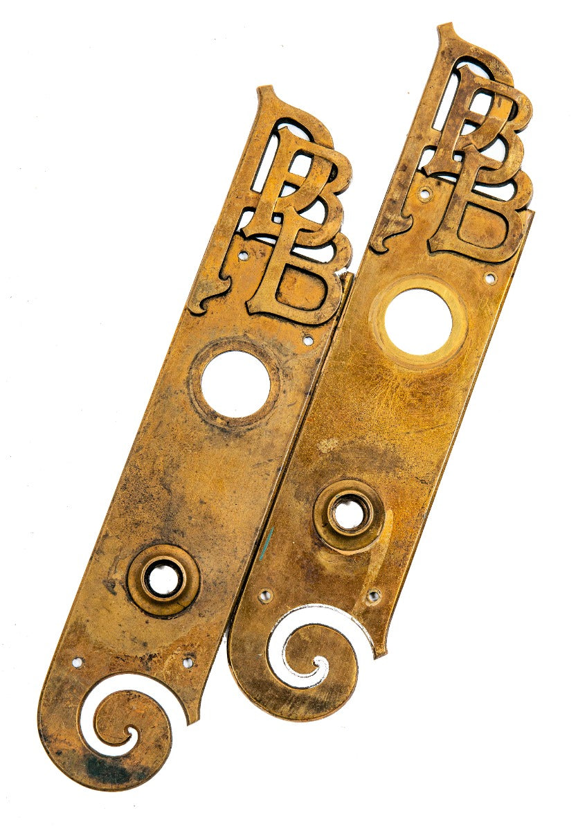 matching pair of unusual late 19th century monogrammed cast brass american commerical building office door backplates