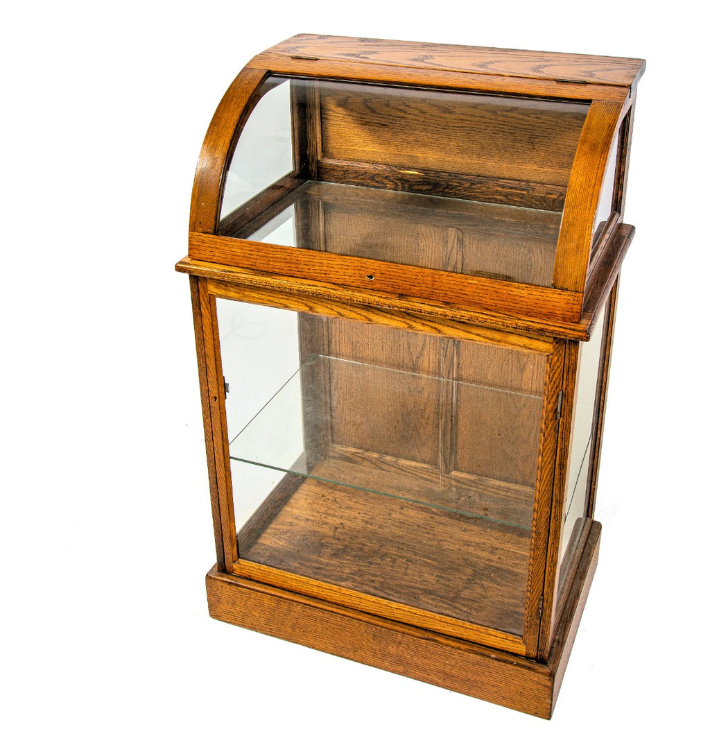 original 19th or early 20th century refinished oak wood freestranding display case with bent glass top and bottom cabinet with shelf