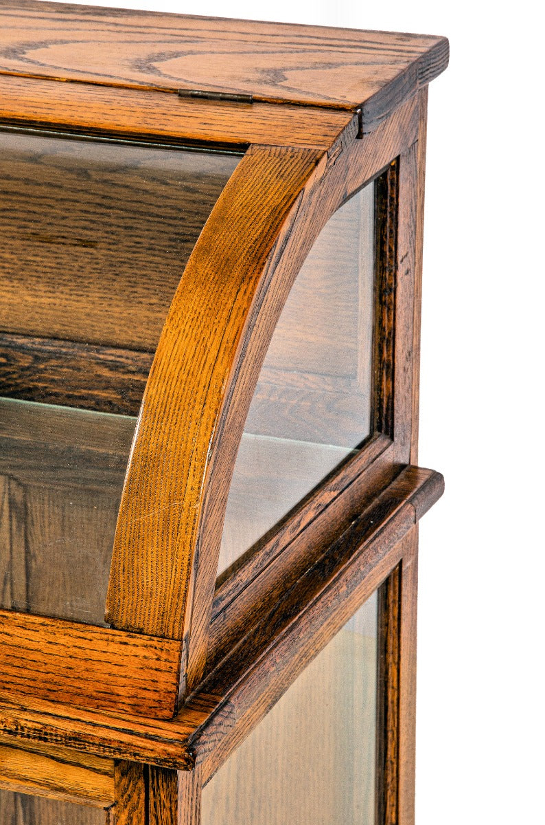 original 19th or early 20th century refinished oak wood freestranding display case with bent glass top and bottom cabinet with shelf