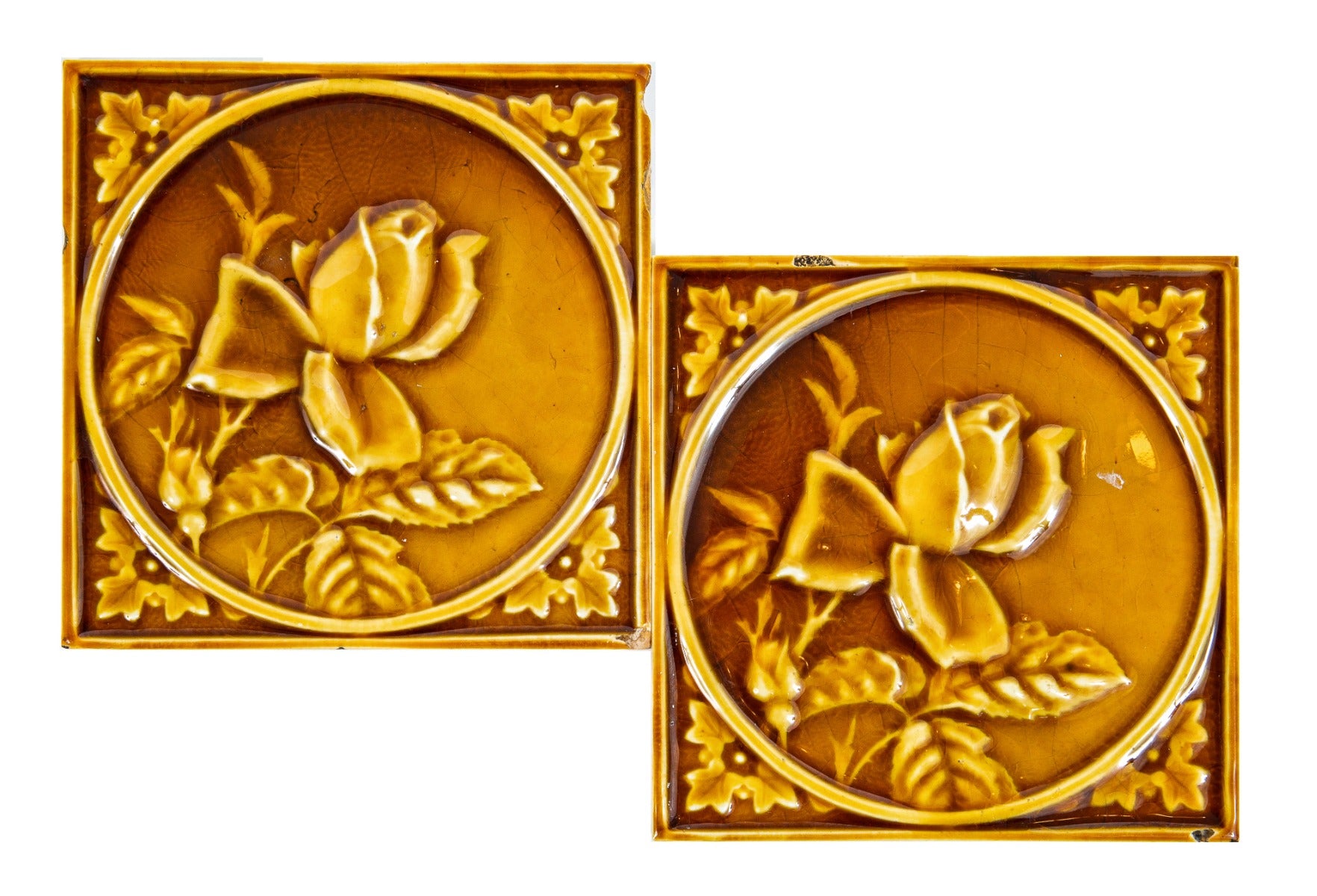 two matching 19th century butterscotch-colored encircled floral motif 6 x 6 fireplace mantel corner tiles