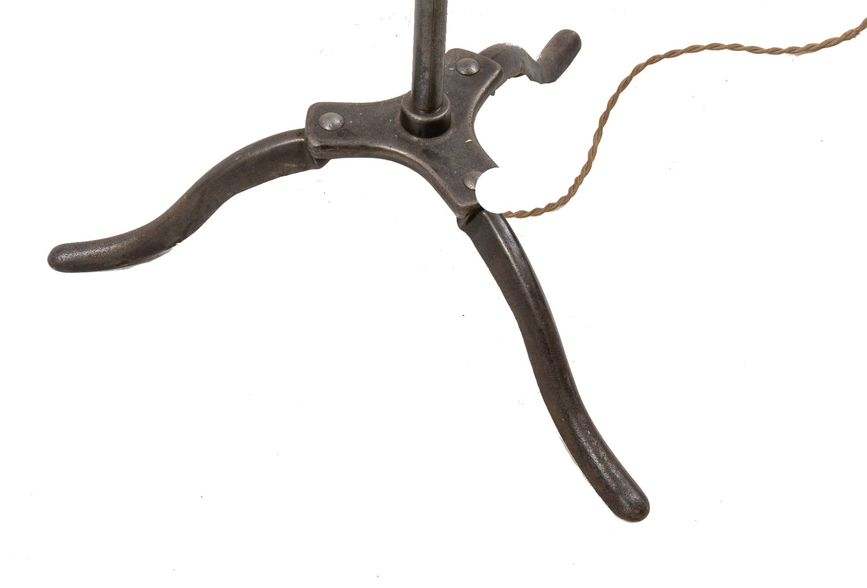 repurposed brushed steel pipe floor lamp with three-legged cast iron base and ruby red explosion proof bulb guard