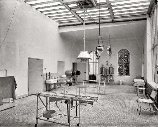 original low-lying c. 1915-20 american antique medical four-legged tubular metal stationary hospital operating room stool with solid steel rod stretchers and pressed and folded seat