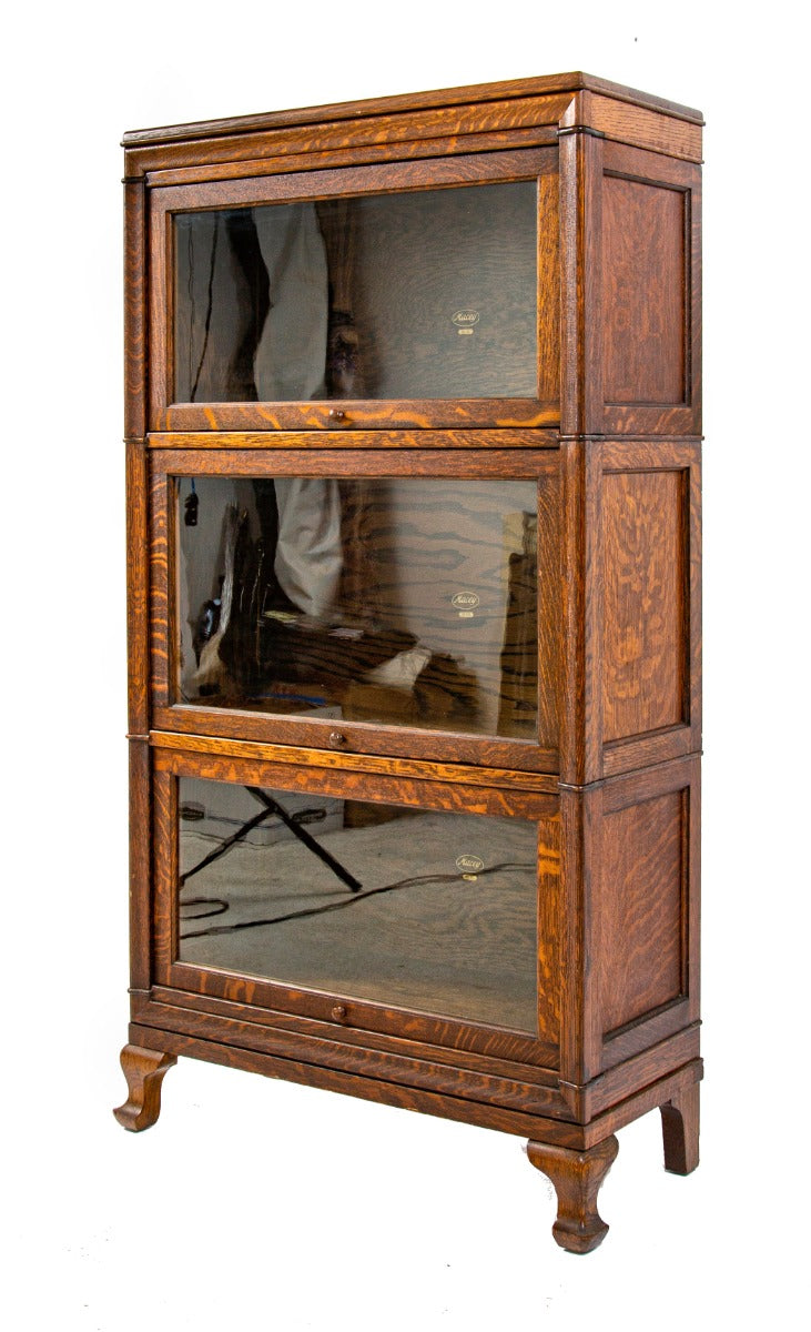 exceptional early 20th century antique american quartered oak wood macey sectional bookcase with four-legged base and header