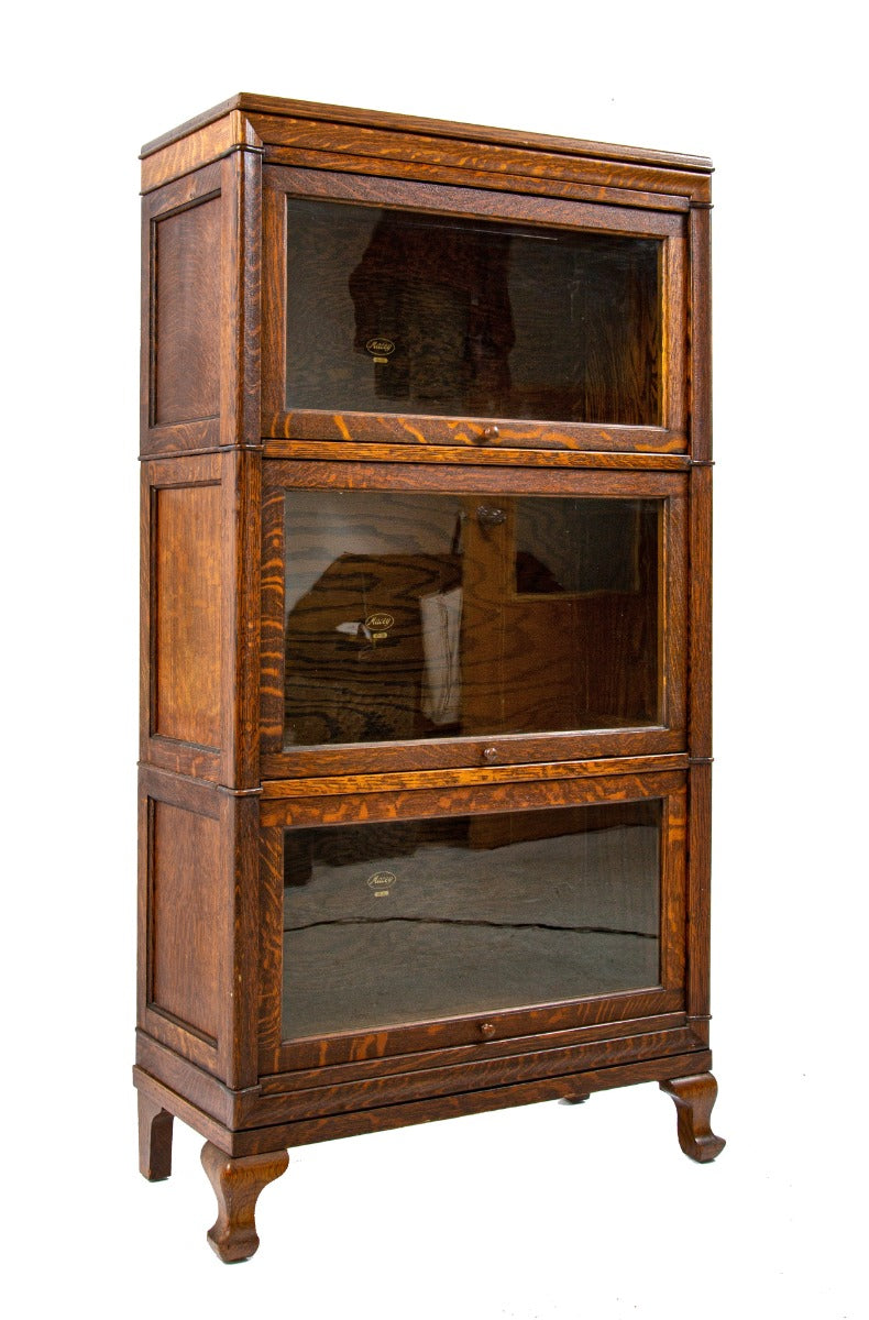 exceptional early 20th century antique american quartered oak wood macey sectional bookcase with four-legged base and header
