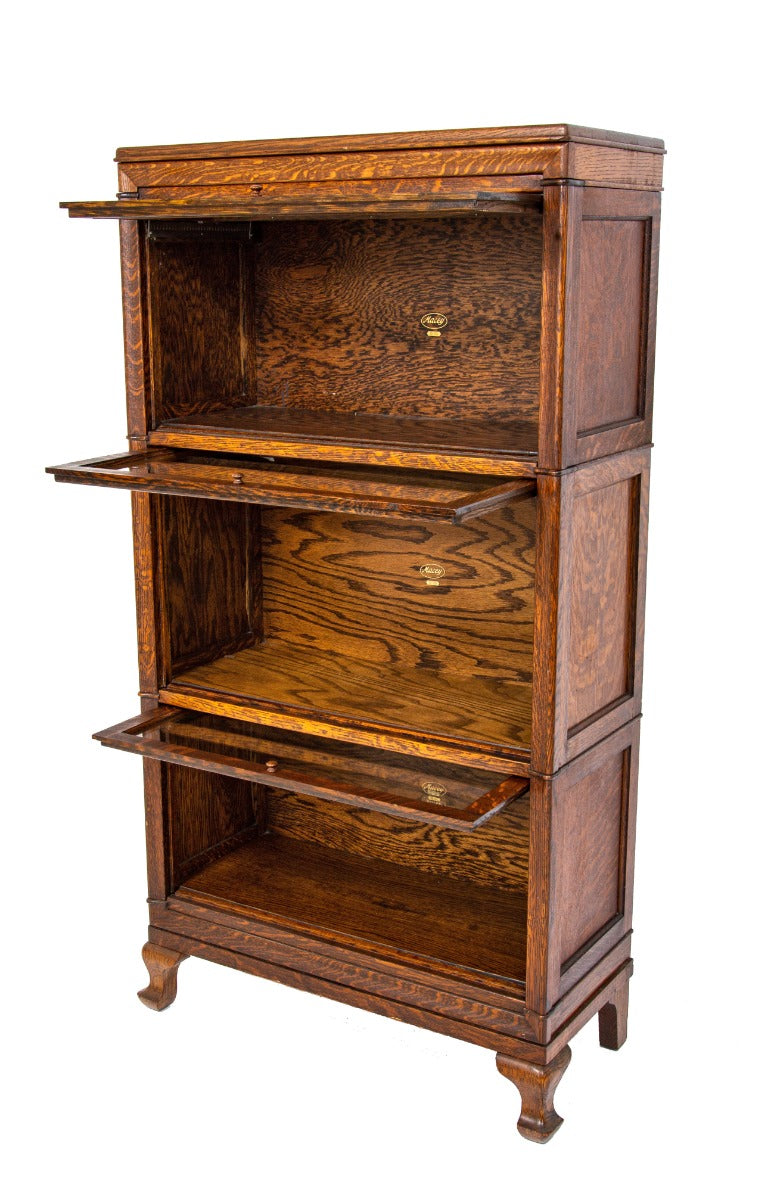 exceptional early 20th century antique american quartered oak wood macey sectional bookcase with four-legged base and header