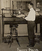 adjustable height turn of the century american antique industrial four-legged oak wood and iron draftsman stool with revolving seat