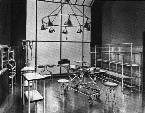 original early 20th century welded joint antique american medical adjustable height hospital examination room swivel chair with armrests and brushed metal finish