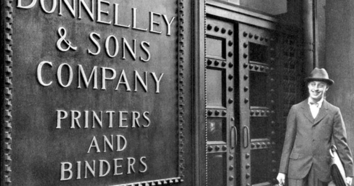 c. 1920's 24-karat gold glazed ornamental terra cotta r.r. donnelley printing plant exterior facade shield with hand trowel