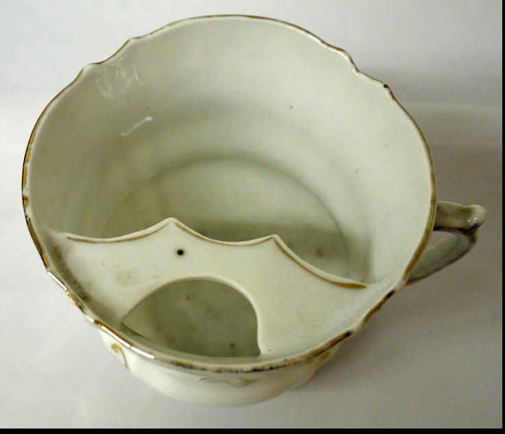 original and unusual antique c. late nineteenth century floral ceramic mustache cup dug from a chicago area privy pit.