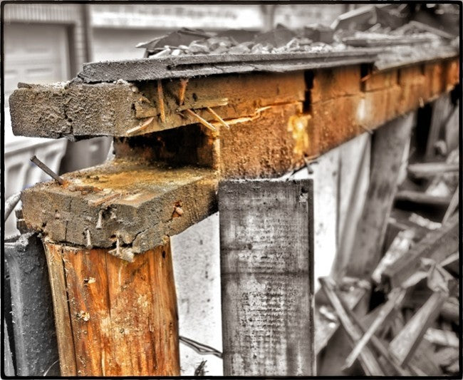 single shortened 19th century chicago balloon frame american industrial solid pine wood residential foundation post or piling repurposed into a freestanding display stand