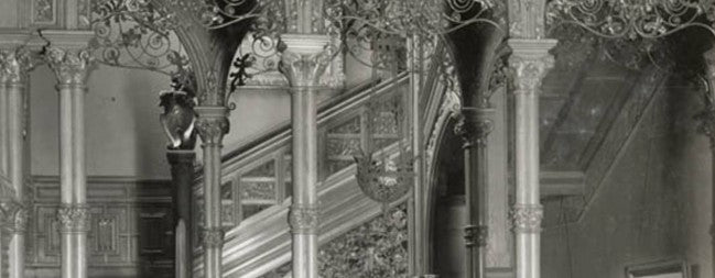original and unrestored 19th century antique american interior residential potter palmer mansion partial intact staircase section with elaborate carving and iron work