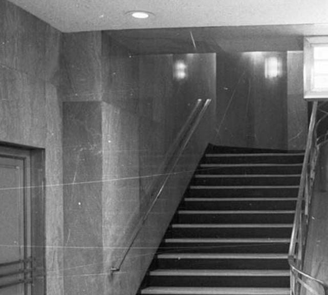 historically-important oversized flush mount american art deco streamlined style chicago board of trade building interior lobby illuminated polished brass wall sconce with cylindrical frosted glass shade