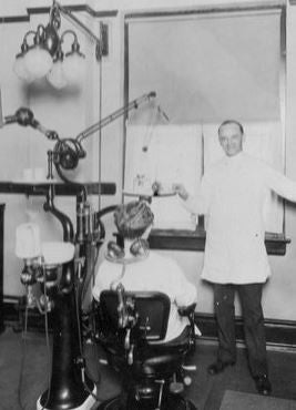 remarkable early 1920's american antique medical interior dentist's office iron and brass illuminated examination "cluster" light with white opalescent "bullet" shape glass globes