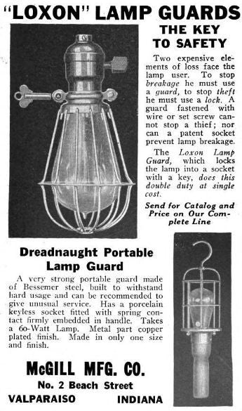 all original and completely intact early 20th century black enameled turned wood handle portable lamp with patented mcgill spring cushion guard or cage