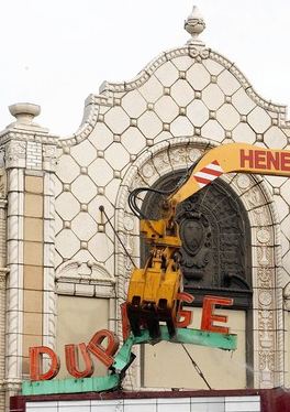 historically important late 1920's american exterior black glazed terra cotta figural dupage theater  facade "comedy" head or mask fragment with flowing hair