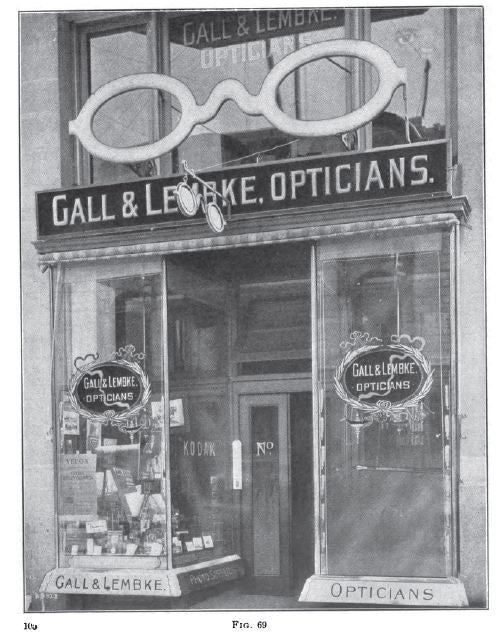 exceptional c. 19th century all original diminutive antique american visually striking optician or optometrist storefront trade sign with original gilded finish over wood and "flash" glass lenses