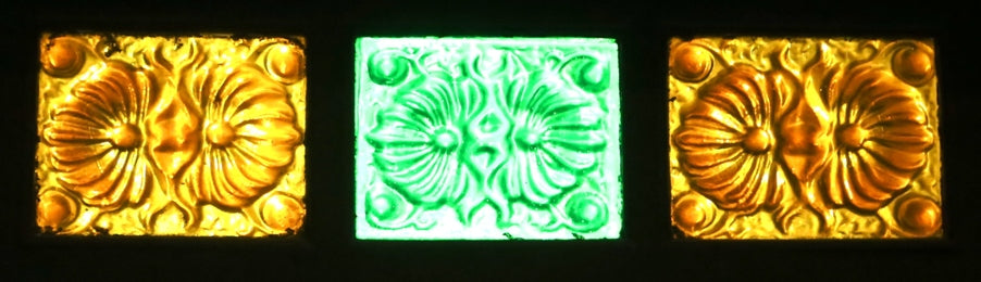 all original and intact late 19th or early 20th century american streetcar transom window amber-colored pressed ornamental glass panel with cube and diagonal flower pattern