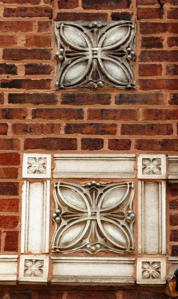 original early 20th century exterior white glazed terra cotta "sullivanesque" style exterior chicago garage salvaged facade element with discoloration