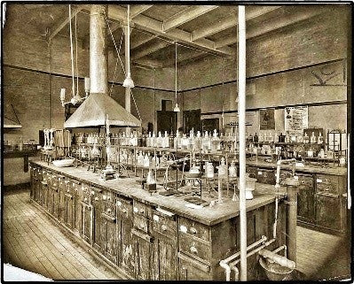 two matching american industrial reinforced clear glass research laboratory reagent bottles with intact ground glass disc-shaped stoppers