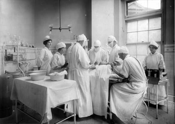 original low-lying c. 1915-20 american antique medical four-legged tubular metal stationary hospital operating room stool with solid steel rod stretchers and pressed and folded seat