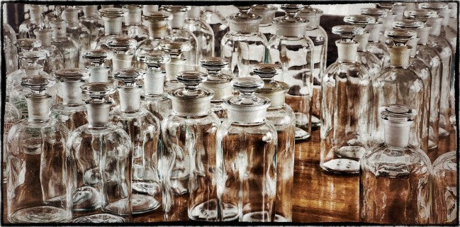 original american vintage industrial cylindrical-shaped clear glass chicago university research laboratory reagent bottles with sloping shoulders and ground glass stoppers