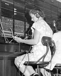 one of two nearly identical american depression era telephone company switchboard chairs or stools with adjustable height seat and curvaceous four-legged base